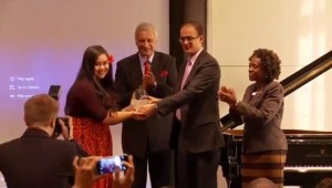 Brianna receives her award from the Commonwealth Secretariat